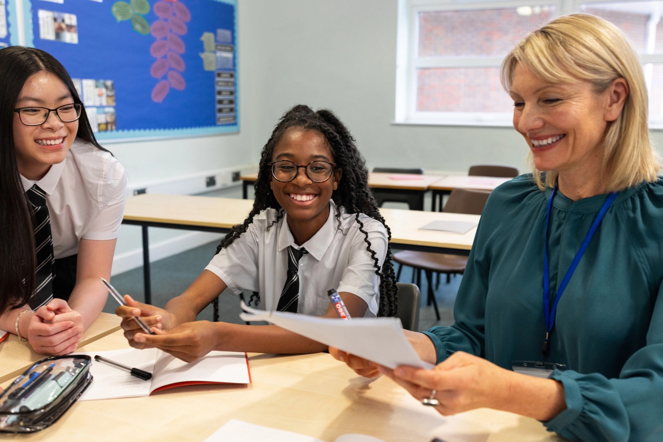 Teacher supporting children in a classroom setting